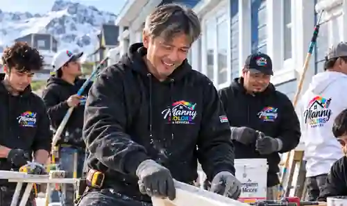 Manny Colors team working on a home exterior in Nuuk